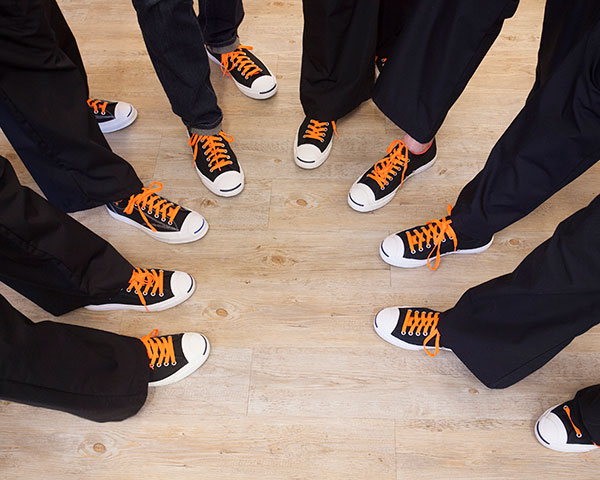 Closeup of dental team's black and orange shoes at orthodontist office Closeup of dental team's black and orange shoes at orthodontist office